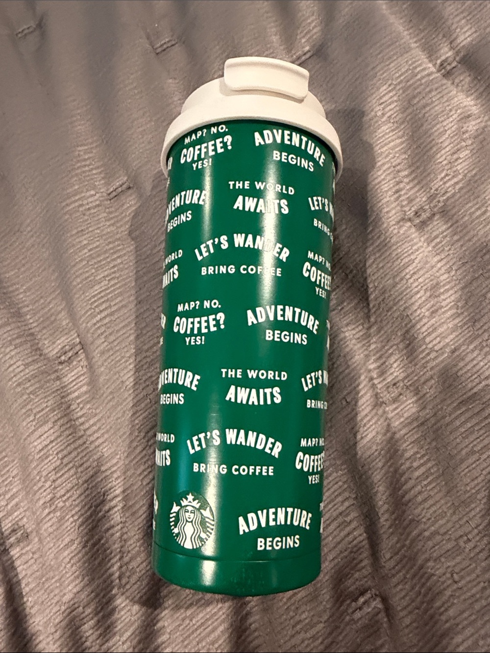 Starbucks green travel tumbler with white text and logo